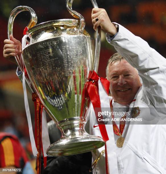 Manchester United manager Sir Alex Ferguson holds up the trophy after beating Chelsea in the final of the UEFA Champions League football match at the...