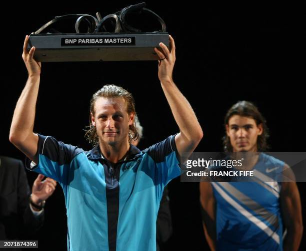 Argentina's David Nalbandian holds his trophy after beating his Spanish opponent Rafael Nadal during their Paris indoor Masters final match, 04...