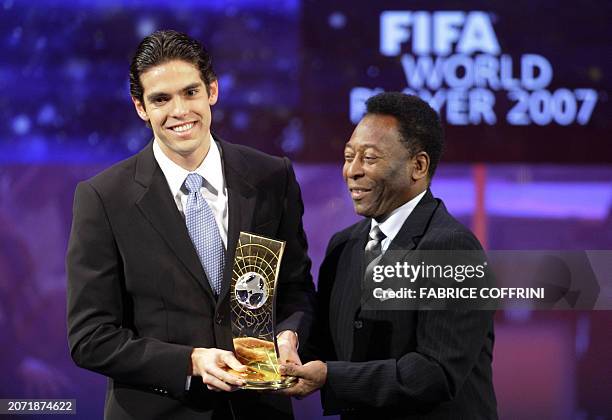 Brazil's football player Kaka smiles as he receives the trophy of FIFA Player of the Year from compatriot football legend Pele during the FIFA World...