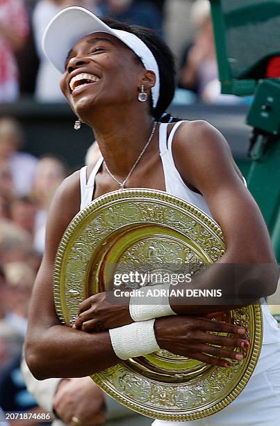 Venus Williams of USA hugs the trophy after defeating Marion Bartoli of France during the final of the Wimbledon Tennis Championships in Wimbledon,...