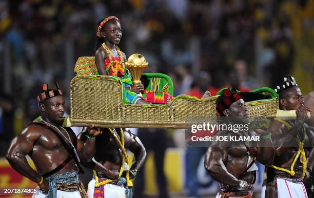 Ghanaian girl brings the trophy after Egypt won the final match between Egypt and Cameroon 1-0 in Accra on February 10, 2008 during the Africa Cup of...