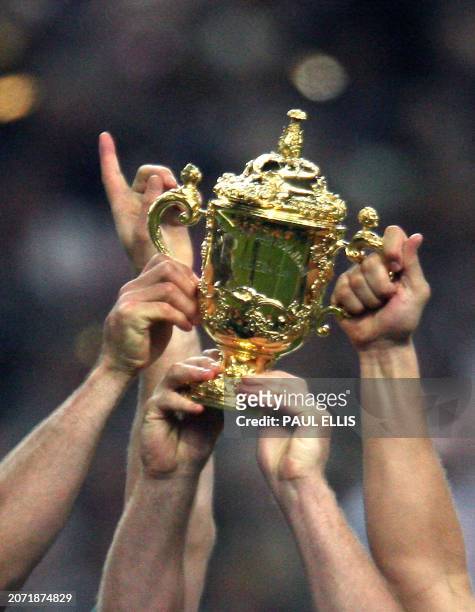 The William Webb Ellis cup is held up by South Africa's players to celebrate their victory on England at the end of the rugby union World Cup final...