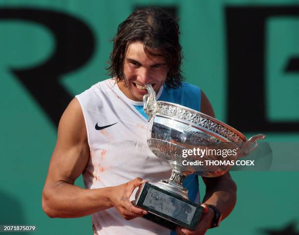 Spanish player Rafael Nadal poses with his trophy after winning the French Tennis Open final match against Swiss player Roger Federer at Roland...