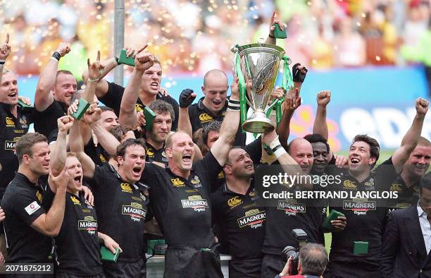 London Wasps' number 8 and captain Lawrence Dallaglio holds the trophy as teammates celebrate after winning the Heineken European Cup rugby union...