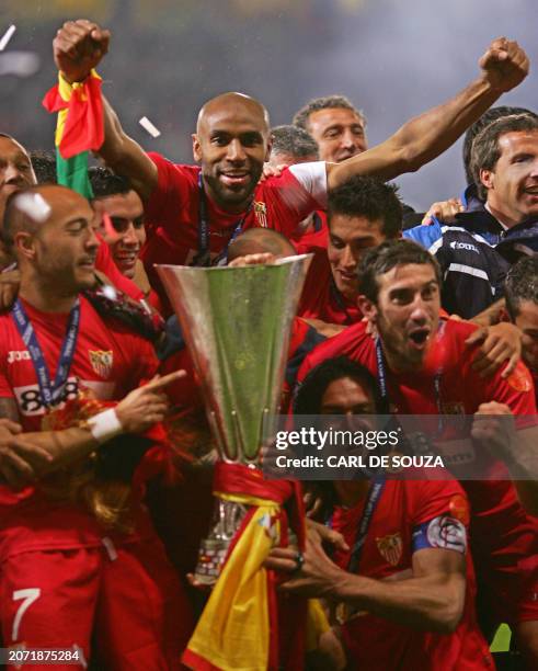 Sevilla's Frederic Kanoute celebrates with teammates as they hold the UEFA Cup Trophy after his side beat Espanyol on penalties at Hampden Park...