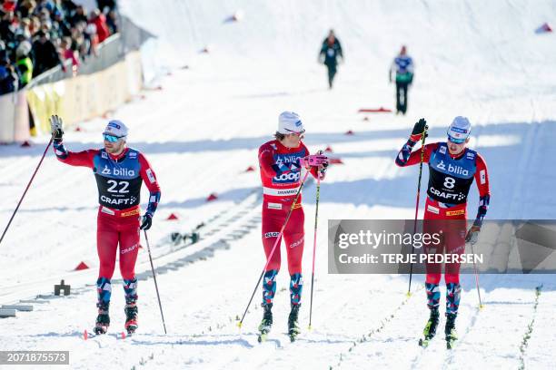 Second placed Norway's Haavard Solaas Taugbol, winner Norway's Johannes Hosflot Klaebo and third placed Norway's Even Northug react after the Men's...