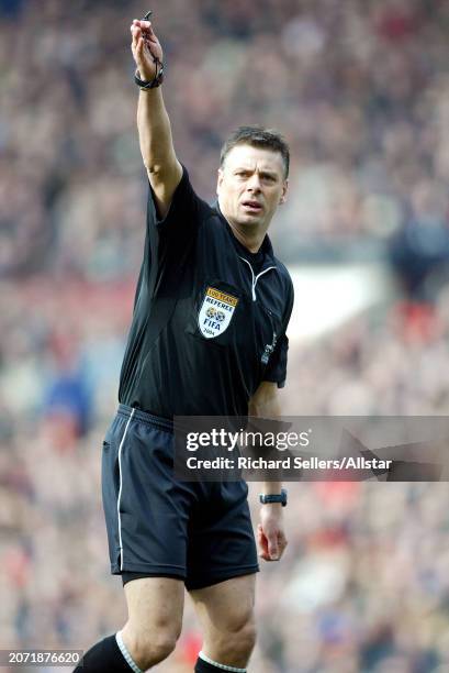 February 21: Mark Halsey, Premier League Referee pointing during the Premier League match between Manchester United and Leeds United at Old Trafford...