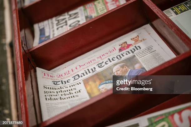 Copies of The Daily Telegraph newspaper for sale on a newsstand in London, UK, on Tuesday, March 12, 2024. Rupert Murdoch's News Corp. And the...