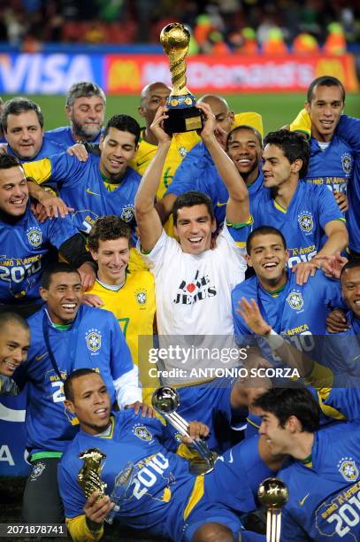 Brazilian captain Lucio holds the trophy while Brazilian forward Luis Fabiano holds his "silver ball" one after the Fifa Confederations Cup final...