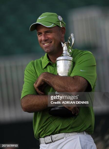 Golfer Stewart Cink hugs the Claret Jug after winning the 138th British Open Championship at Turnberry Golf Course in south west Scotland, on July...
