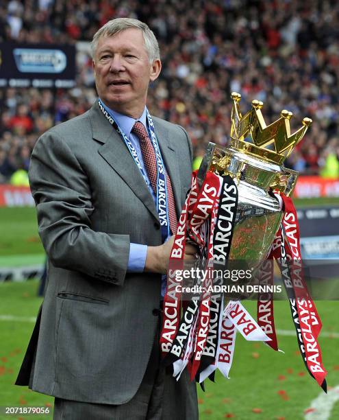 Manchester United manager Sir Alex Ferguson with the English Premier League trophy after the 0-0 draw with Arsenal in the English Premier League...