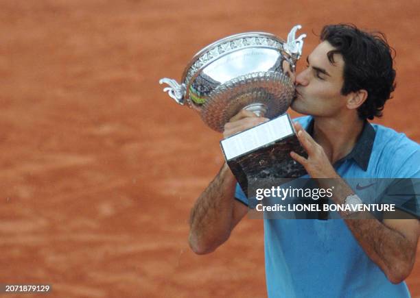 Swiss Roger Federer kisses the trophy after winning against Swedish player Robin Soderling during their French Open tennis men's final match on June...