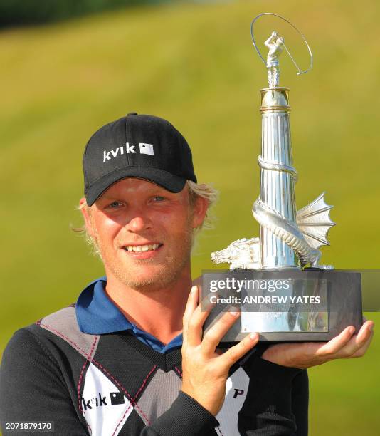 Jeppe Huldahl of Denmark holds the Wales Open golf championship trophy at Celtic Manor, Newport, south Wales on June 7, 2009. AFP PHOTO ANDREW YATES