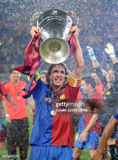 Barcelona´s captain and defender Carles Puyol holds the Champions League Cup on May 27, 2009 during the trophy ceremony at the Olympic Stadium in...