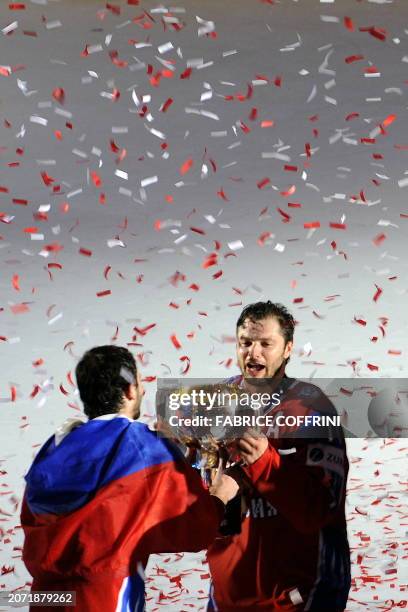 Russia's Oleg Tverdovsky and his teammate Alexander Radulov celebrate with the trophy after winning 2-1 against Canada during final game at the 2009...