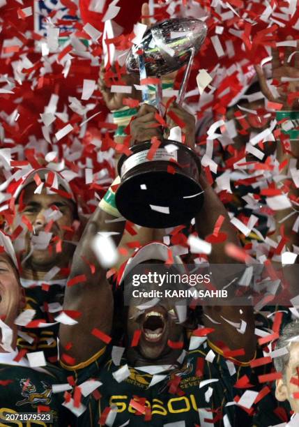 South Africa's Mpho Mbiyozo celebrates with the trophy after beating England in their IRB World Sevens Series final match on the last day of the...
