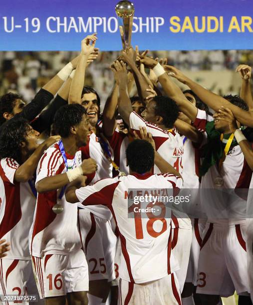 Emirati players celebrate with the trophy after beating Uzbekistan in their AFC Under-19 Championship final football match in the Saudi eastern city...