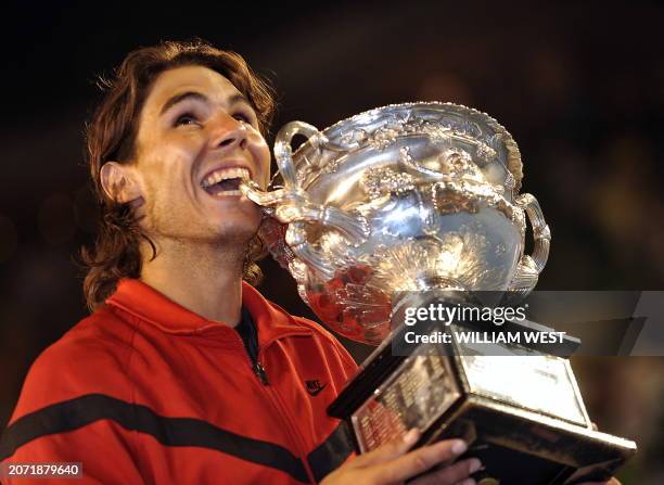 Rafael Nadal of Spain holds the trophy as he celebrates defeating Roger Federer of Switzerland after the men's tennis final on day 14 of the...