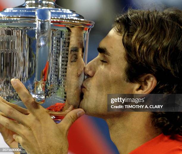 Roger Federer of Switzerland kisses his trophy after winning his men's final match against Andy Murray of Great Britain in the US Open tennis...