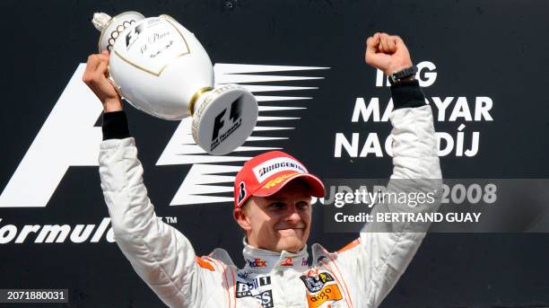 McLaren Mercedes' Finnish driver Heikki Kovalainen celebrates on the podium of the Hungaroring racetrack on August 3, 2008 in Budapest after the...