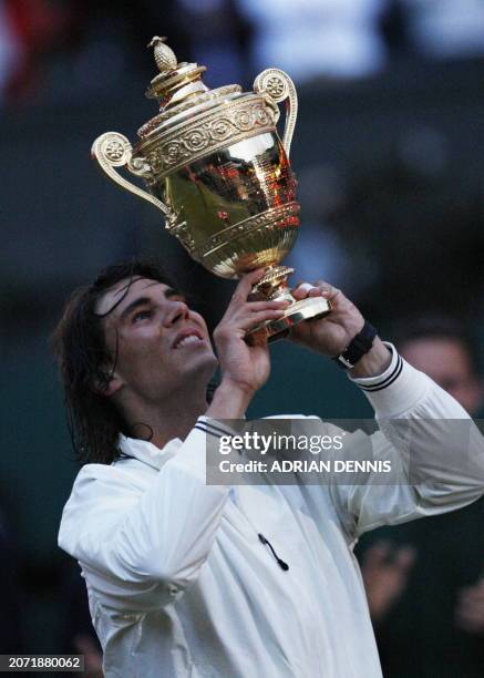 Spain's Rafael Nadal holds his trophy after defeating Switzerland's Roger Federer during their final tennis match of the 2008 Wimbledon championships...