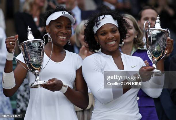 Venus and Serena Williams celebrate after beating Lisa Raymond of USA and Samantha Stosur of Australia 6-2, 6-2, in the Women's Doubles Final during...