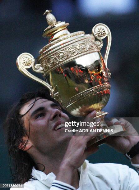 Spain's Rafael Nadal holds his trophy after defeating Switzerland's Roger Federer during their final tennis match of the 2008 Wimbledon championships...