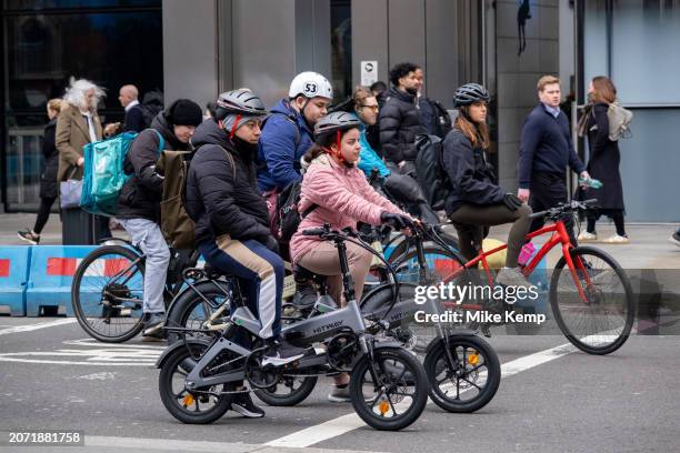 Cyclists on various types of bicycles including two Hitway electric bikes waiting at the traffic lights on 3rd March 2024 in London, United Kingdom....