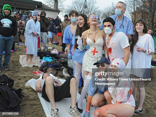 Group from Orange County dressed in medical outfits get ready to run in the water at the Annual Lake George Polar Plunge at Shepard Park Beach on...