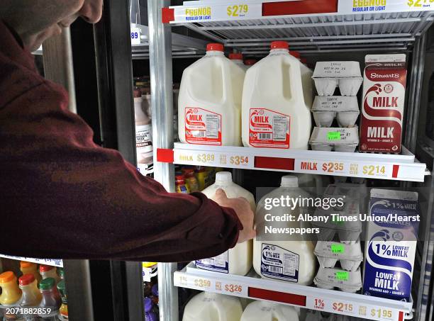 Customer reaches for a gallon of 1% milk at a Stewart's Shops on Friday, Jan. 2, 2015 in Latham, N.Y. Stewart's Shops will be lowering their milk...