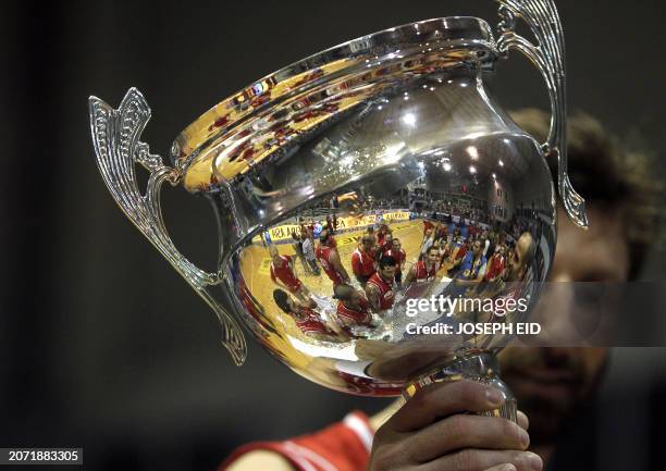 Lebanon's national basketball team players are reflected in the trophy as they celebrate after winning the FIBA Asia Stankovic Cup final basketball...