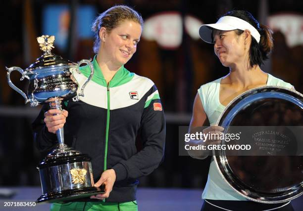 Kim Clijsters of Belgium poses with the winner's trophy after beating runner-up Li Na of China who holds her shield after the women's singles final...