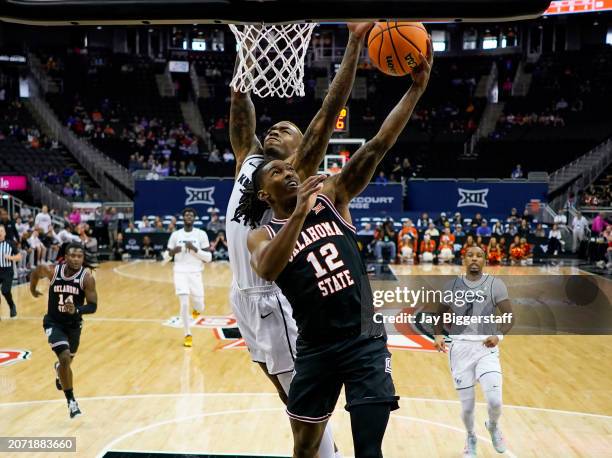 Javon Small of the Oklahoma State Cowboys shoots against C.J. Walker of the UCF Knights during the first half of the Big 12 Men's Basketball...