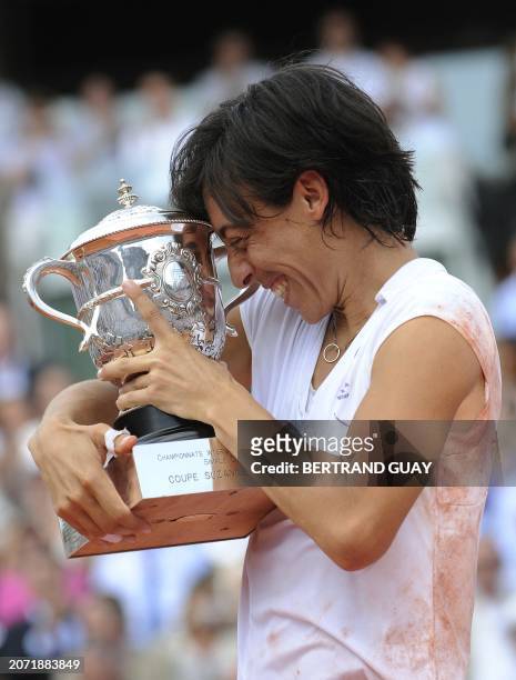 Italy's Francesca Schiavone poses with her trophy after she defeated Australia's Samantha Stosur at the end of their women's final match in the...