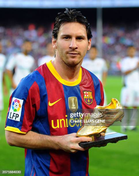 Barcelona's Argentinian forward Lionel Messi poses with his Bota de Oro 2010's trophy awarded as the best European player on October 3, 2010 prior to...
