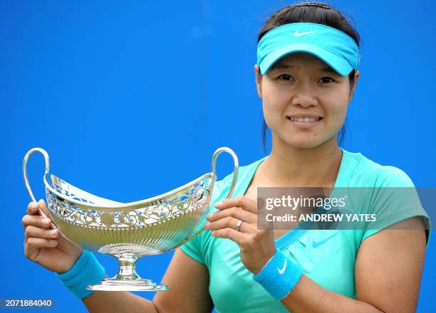 Tennis player Na Li of China holds the Maud Watson trophy after beating Maria Sharapova of Russia 7-5 6-1 in the final of the AEGON Classic tennis...
