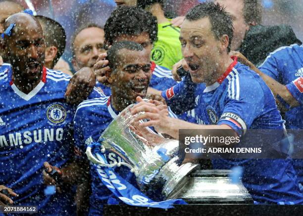 Chelsea's captain John Terry reaches for the FA Cup Trophy after it fell from the plinth following victory over Portsmouth during the FA Cup Final...