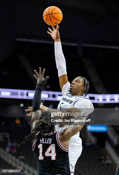 Omar Payne of the UCF Knights shoots over Jamyron Keller of the Oklahoma State Cowboys during the first half of the Big 12 Men's Basketball...