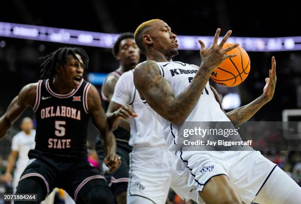 Walker of the UCF Knights grabs a loose ball during the first half against the Oklahoma State Cowboys of the Big 12 Men's Basketball Tournament at...