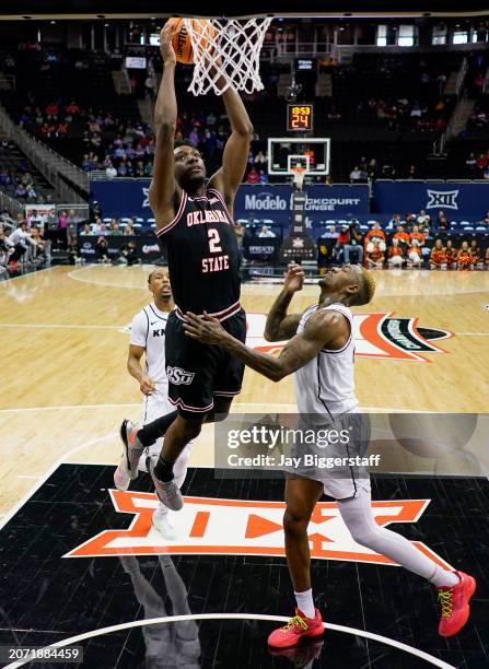 Eric Dailey Jr. #2 of the Oklahoma State Cowboys dunks the ball against C.J. Walker of the UCF Knights during the first half of the Big 12 Men's...