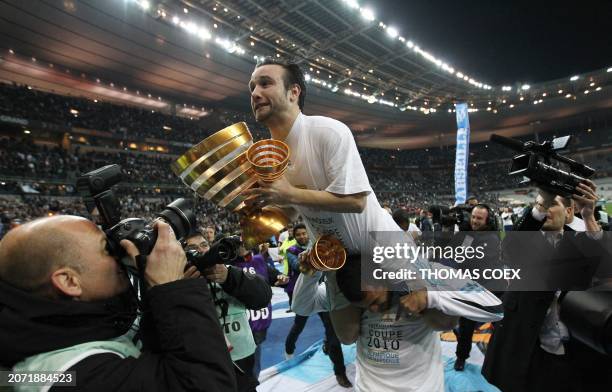 Marseille's midfielder Mathieu Valbuena celebrates with his trophies after winning the League Cup final match Marseille vs. Bordeaux on March 27,...