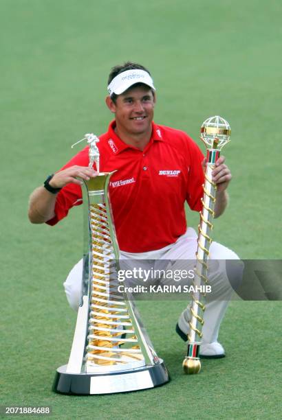 England's Lee Westwood poses with his trophies after winning the Dubai World Championship at the Earth Course at Jumeirah Golf Estates in Dubai on...