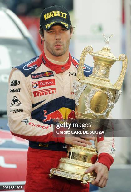 Rally driver, Sebastien Loeb of France holds the World Rally Championship trophy after winning the Rally of Great Britain, Cardiff, Wales on October...