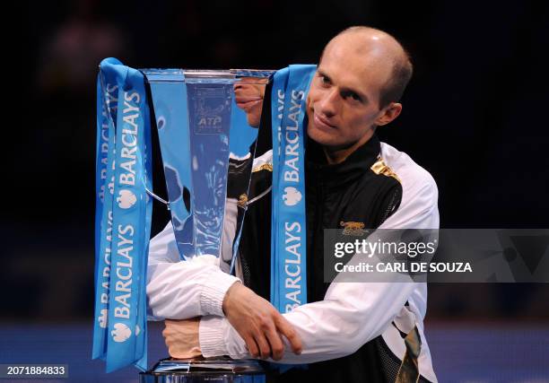 Nikolay Davydenko of Russia celebrates with the trophy after beating Juan Martin Del Potro of Argentina in the singles final match during the...