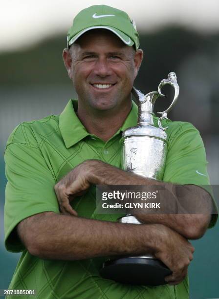 Golfer Stewart Cink hugs the Claret Jug after winning the 138th British Open Championship at Turnberry Golf Course in south west Scotland, on July...