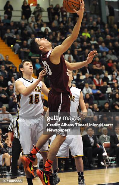 Scotia-Glenville's Michael Palleschi goes up for a reverse lay up during the Class A boys' basketball state final against Greece Athena on Sunday,...