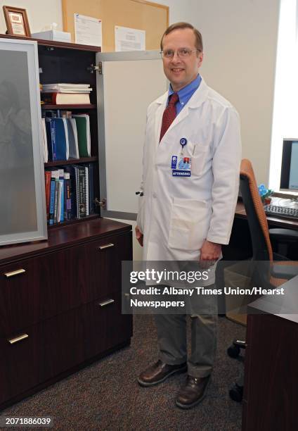 Dr. Luke Pluto, who helps patients with sleep disorders, stands by his book shelf and filing cabinet in his office on Monday, March 23, 2015 in...