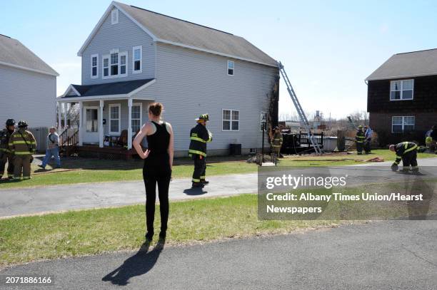 Firefighters finish putting out a house fire at 12 Lafayette Park which started in the hot tub on the back deck Wednesday, April 15, 2015 in Green...