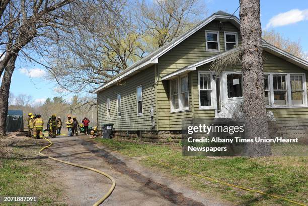 Firefighters finish extinguishing a kitchen fire in a house at 4355 Western Turnpike on Thursday, April 30, 2015 in Guilderland, N.Y.