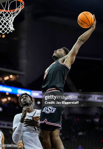 Eric Dailey Jr. #2 of the Oklahoma State Cowboys dunks the ball against Ibrahima Diallo of the UCF Knights during the second half of the Big 12 Men's...